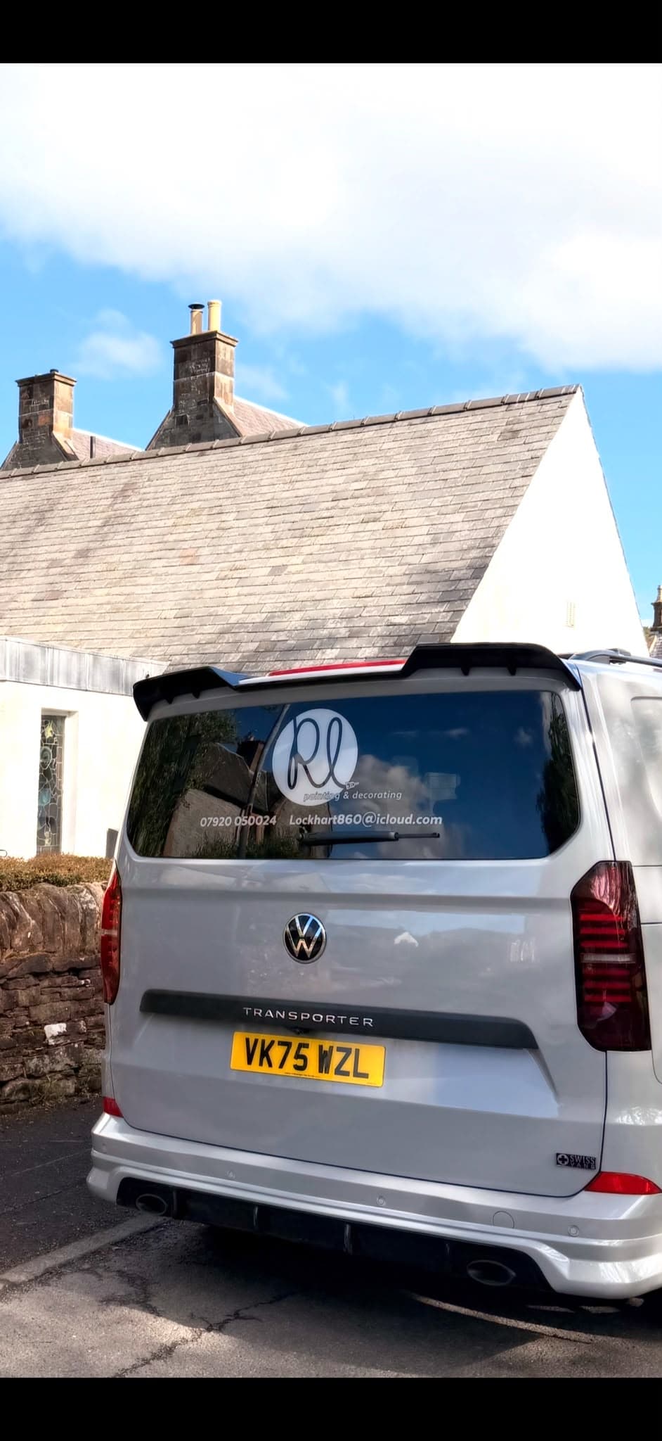 Ricky Lockhart's branded work van parked at a completed painting and decorating project