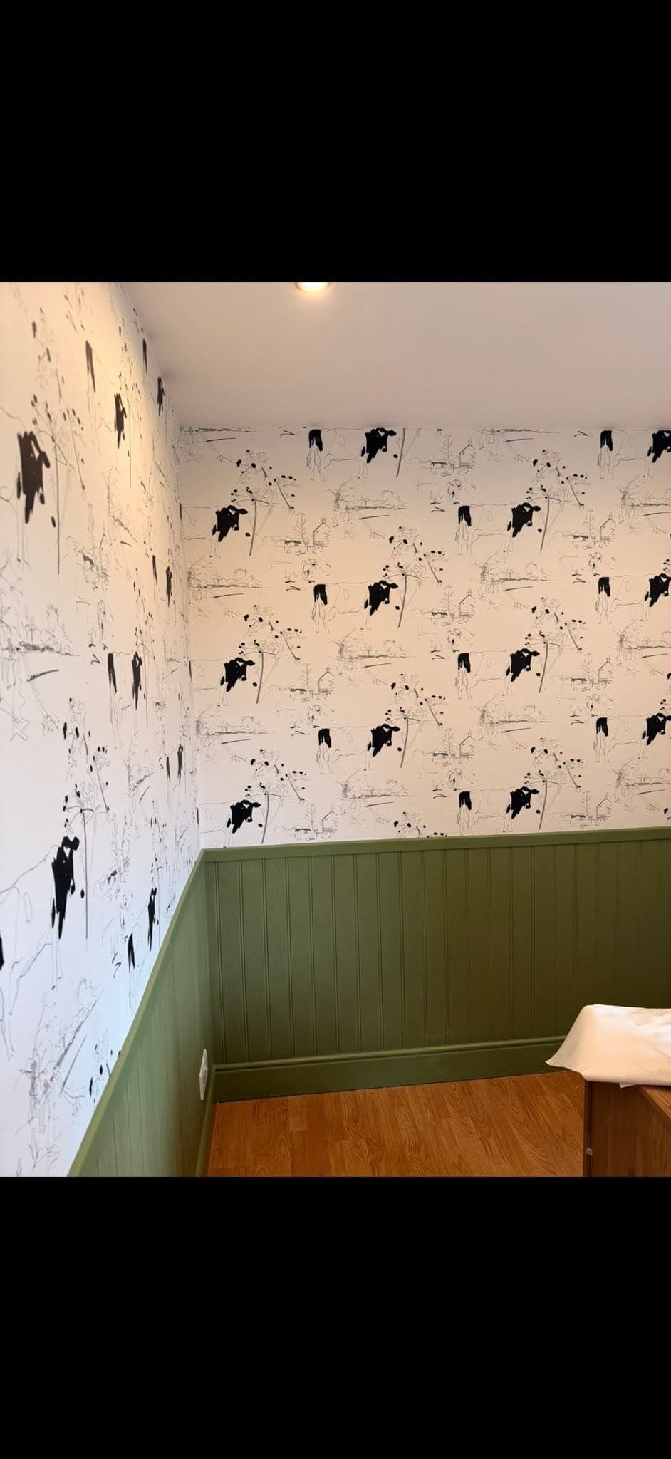 Feature wall finished in a bold patterned printable wallpaper with seamless joins